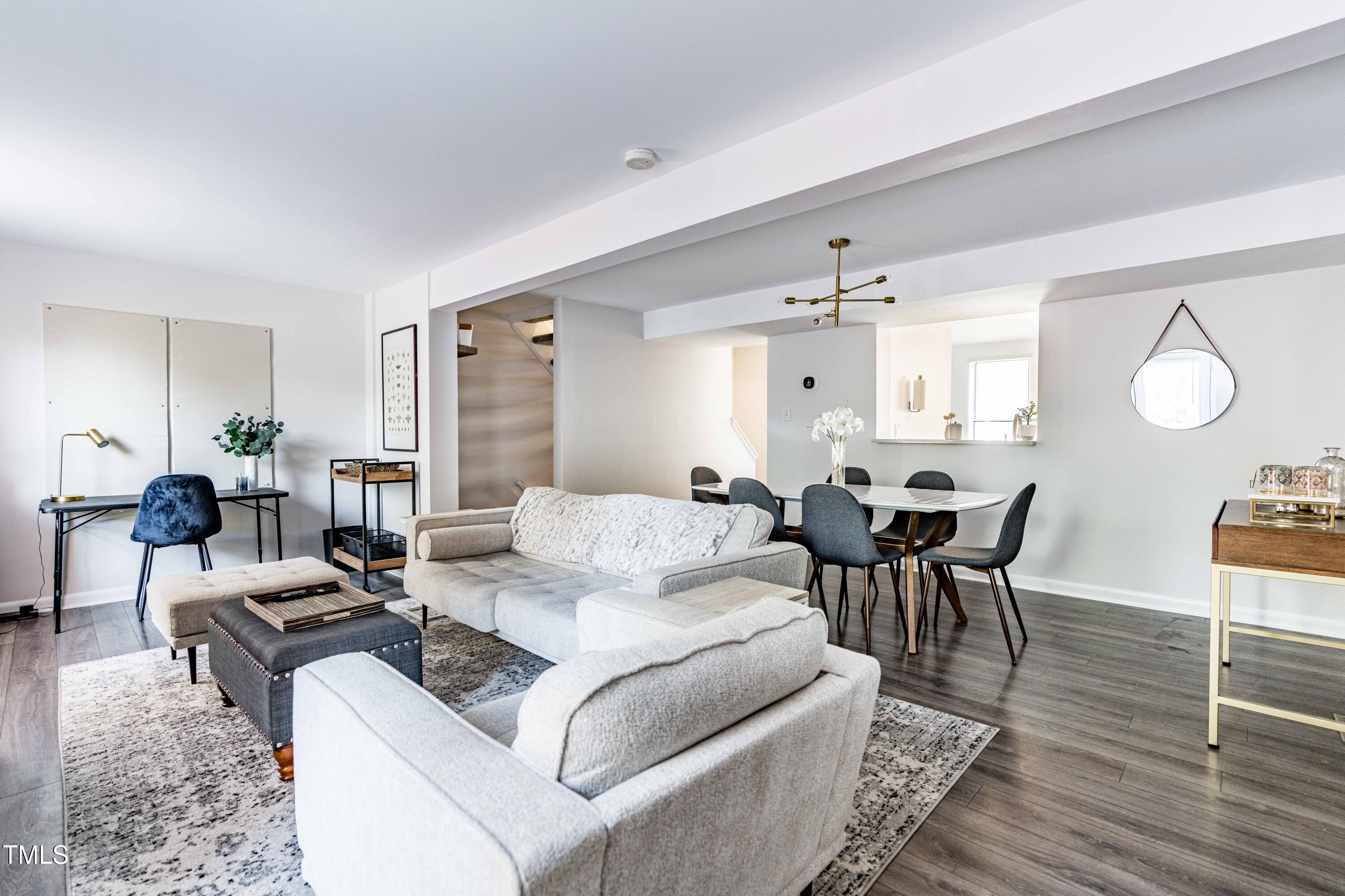 1708 Ithaca Lane, Unit A Raleigh, NC 27606 - Photo 15 of 30 a living room with furniture a rug and a chandelier