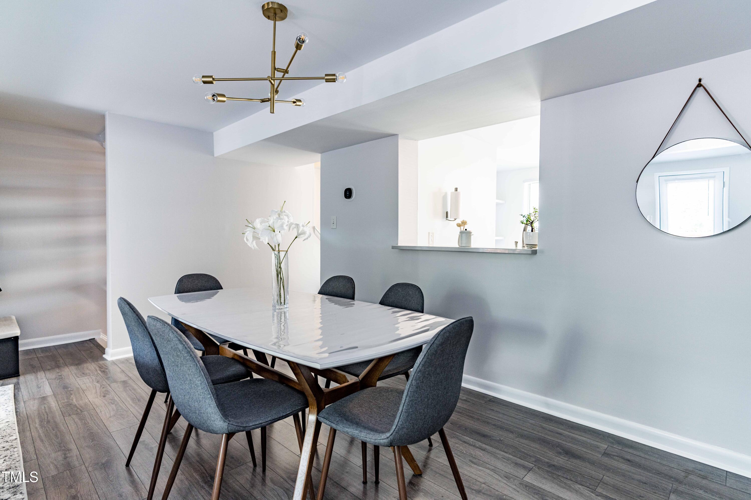 1708 Ithaca Lane, Unit A Raleigh, NC 27606 - Photo 16 of 30 a view of a dining room with furniture and wooden floor