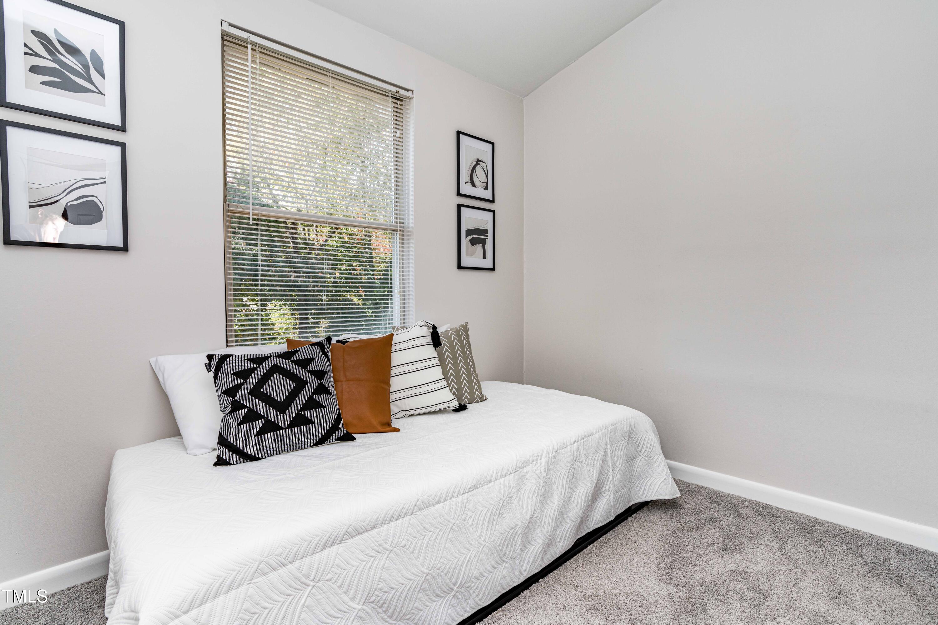 1708 Ithaca Lane, Unit A Raleigh, NC 27606 - Photo 17 of 30 a bedroom with a bed and wooden floor