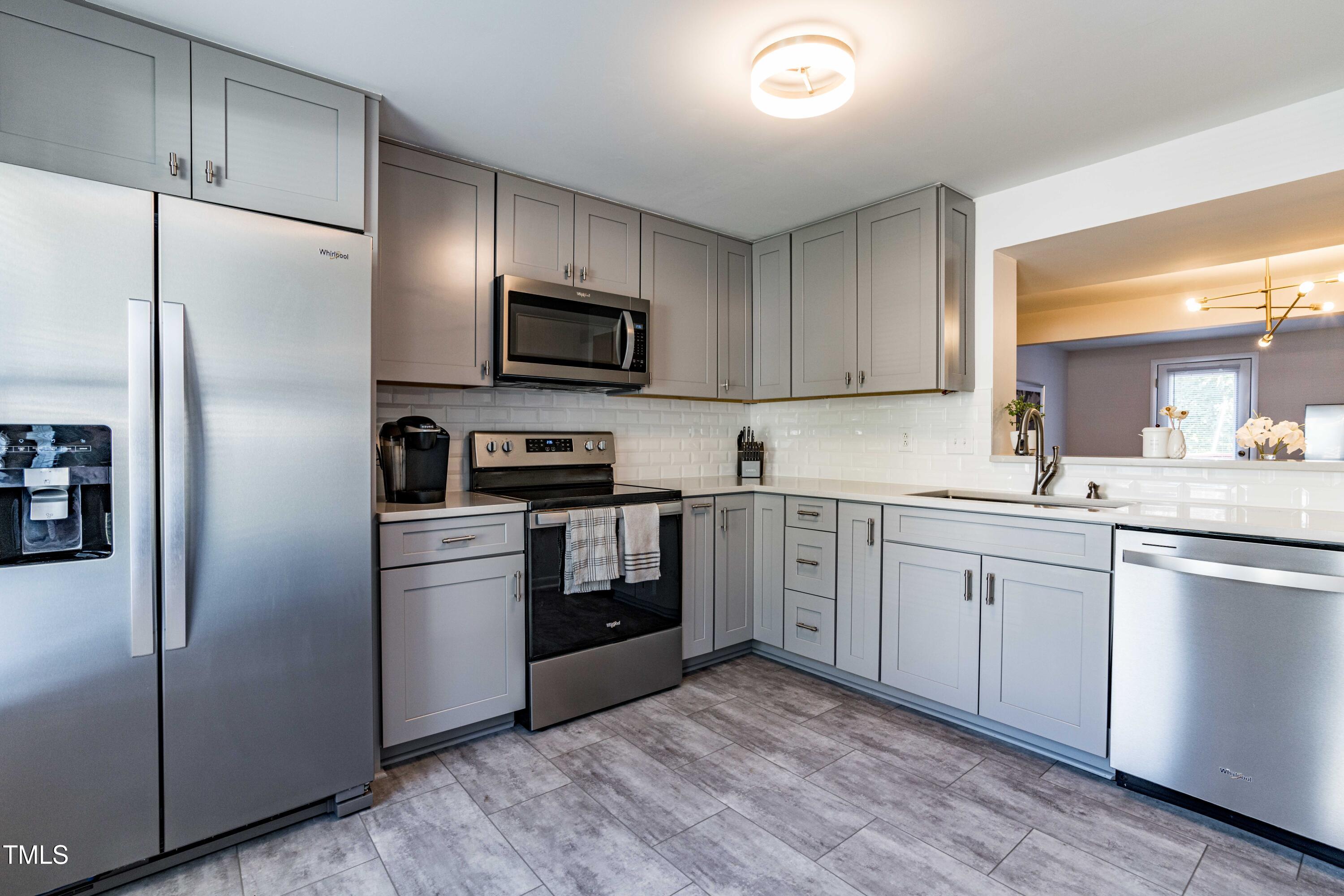 1708 Ithaca Lane, Unit A Raleigh, NC 27606 - Photo 2 of 30 a kitchen with cabinets stainless steel appliances and a window