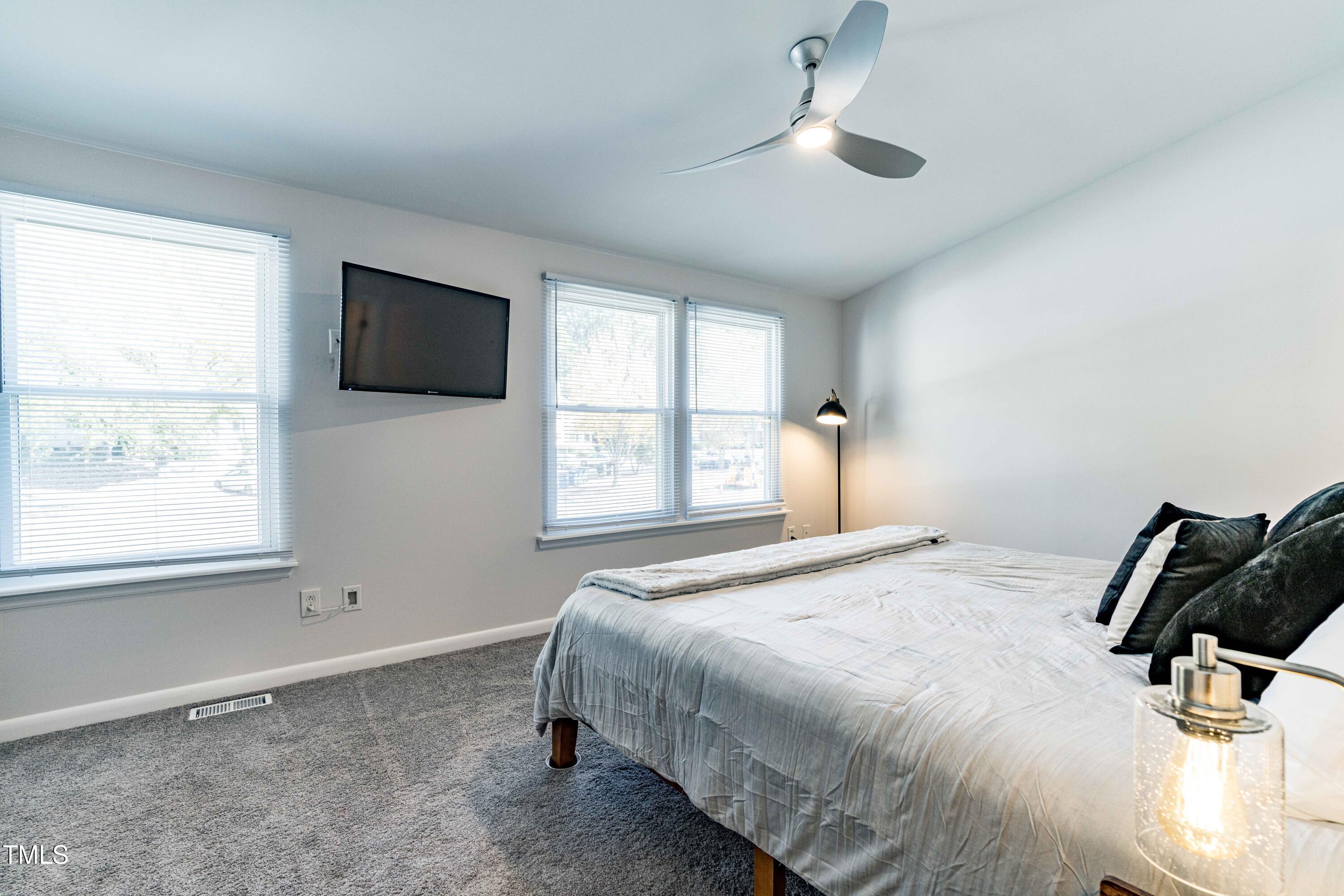 1708 Ithaca Lane, Unit A Raleigh, NC 27606 - Photo 22 of 30 a bedroom with a bed and a flat screen tv