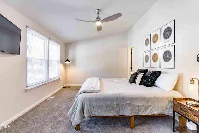 a bedroom with a large bed and a window