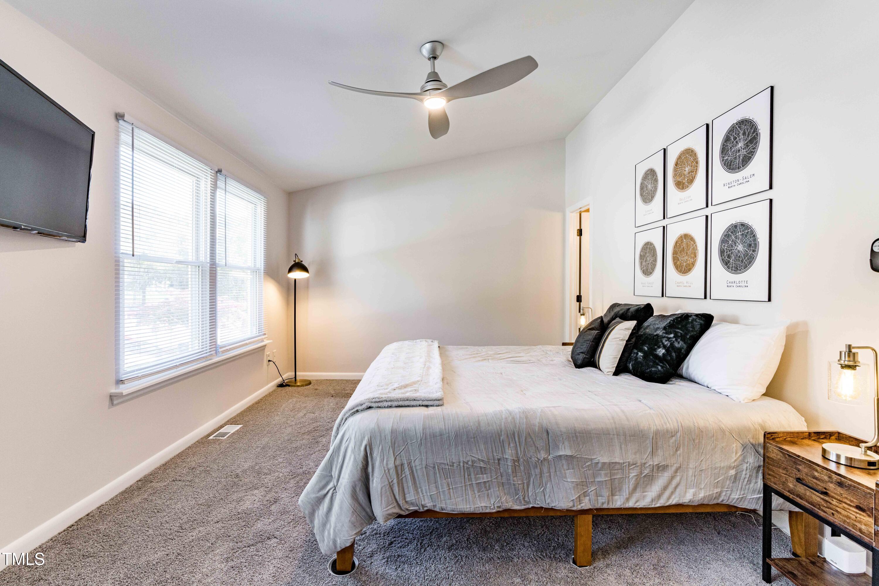 1708 Ithaca Lane, Unit A Raleigh, NC 27606 - Photo 23 of 30 a bedroom with a large bed and a window