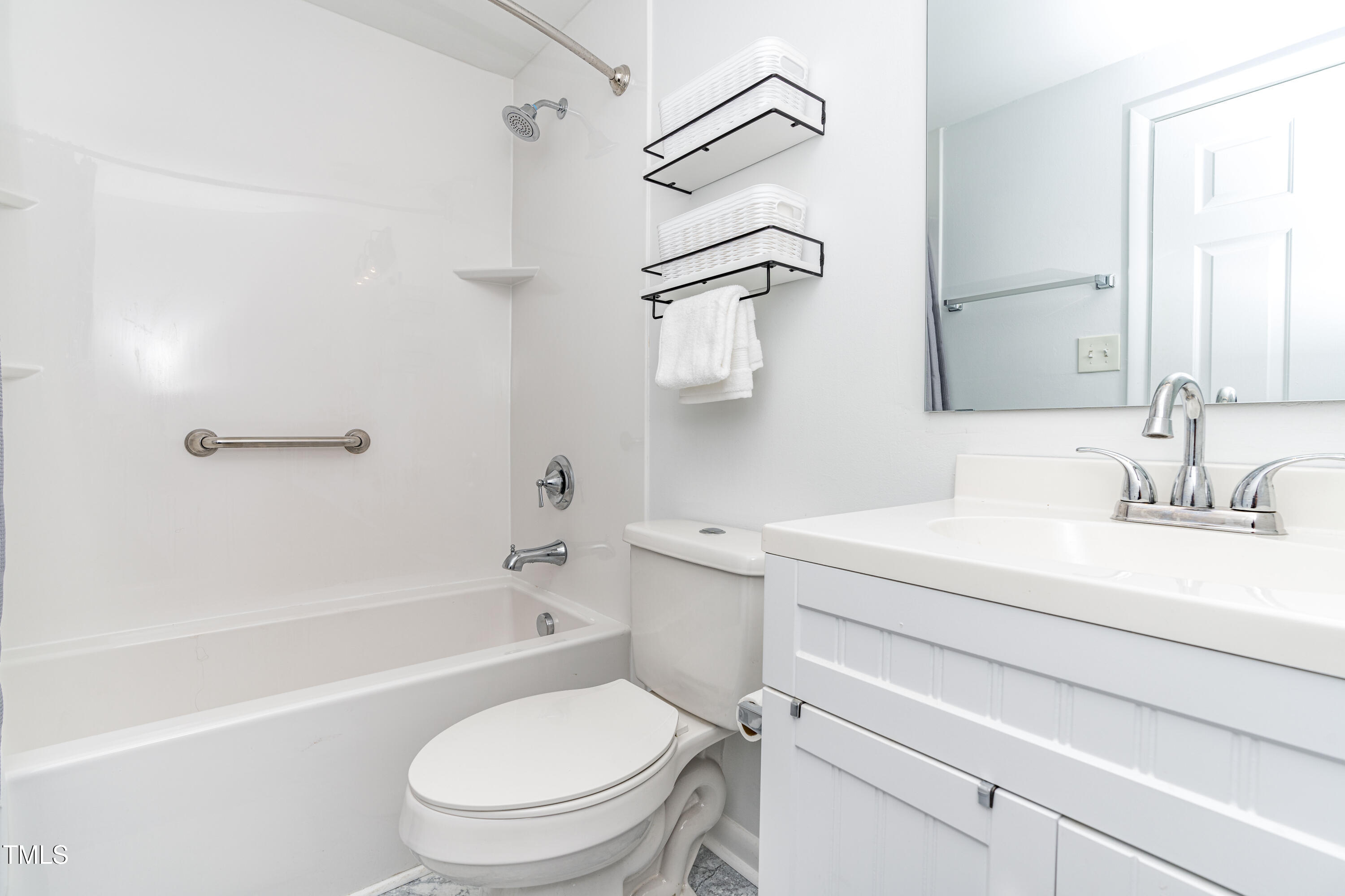 1708 Ithaca Lane, Unit A Raleigh, NC 27606 - Photo 28 of 30 a bathroom with a sink a toilet and a bathtub