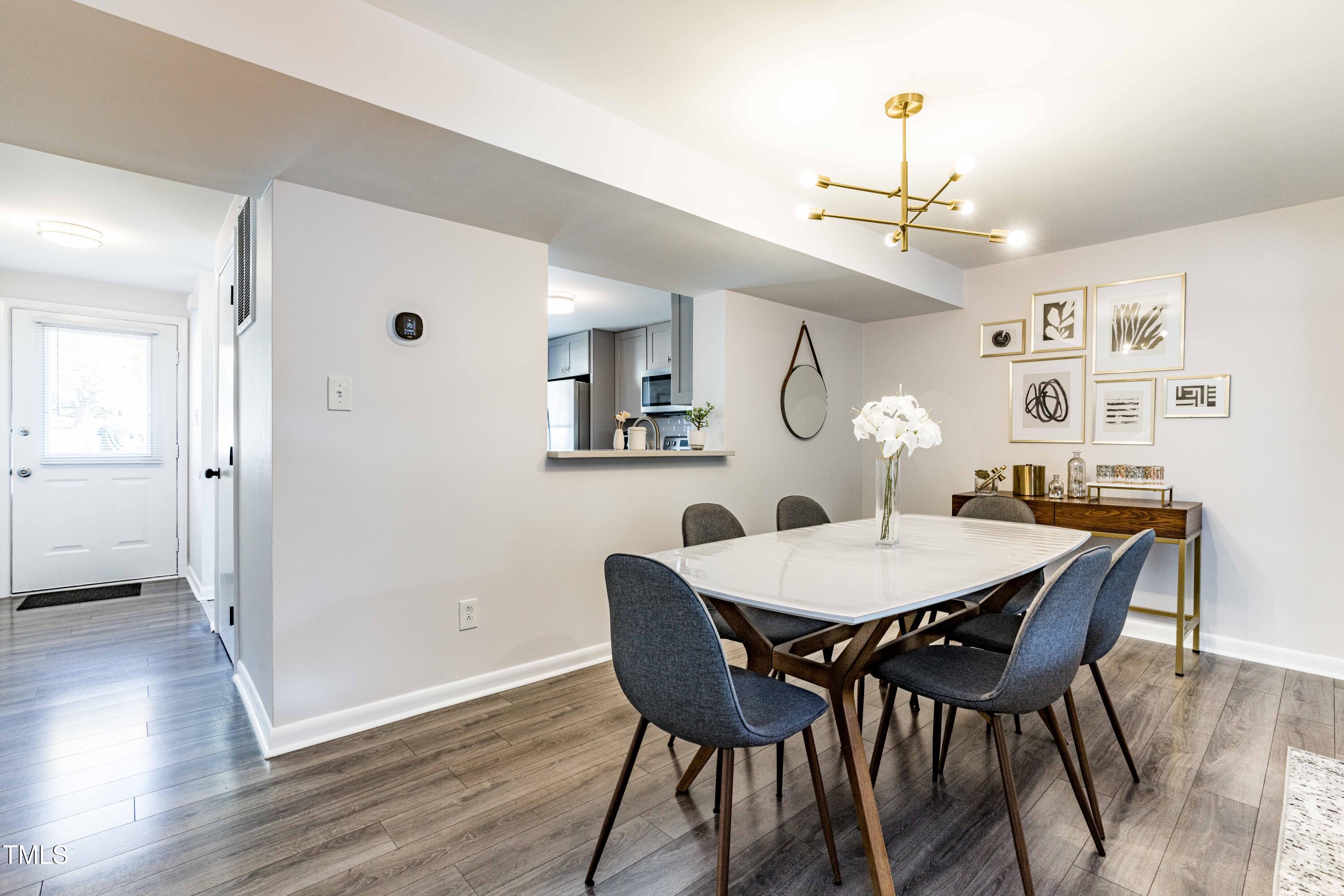 1708 Ithaca Lane, Unit A Raleigh, NC 27606 - Photo 3 of 30 a view of a dining room with furniture and wooden floor