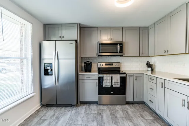a kitchen with stainless steel appliances a refrigerator stove and sink