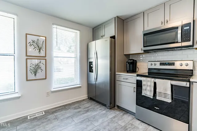a kitchen with a refrigerator stove and microwave