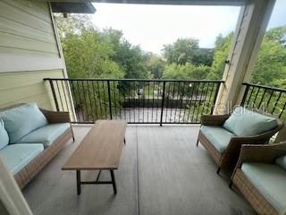 1235 Southwest 9th Road, Unit 303 Gainesville, FL 32601 - Photo 1 of 1 a balcony with wooden floor and outdoor seating