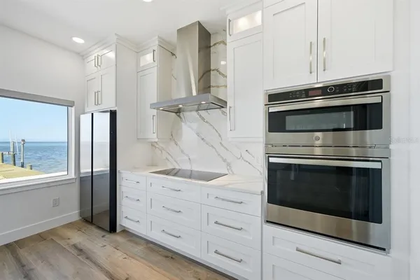 a kitchen with granite countertop a stove and a microwave