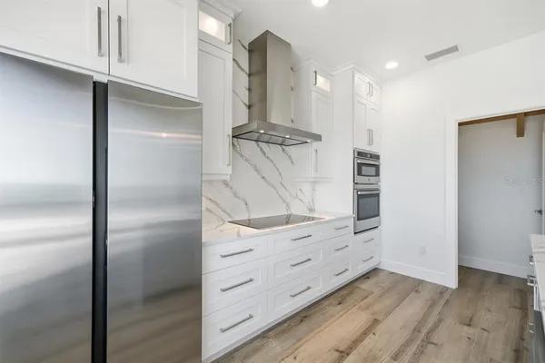 a kitchen with a sink a center island and cabinets