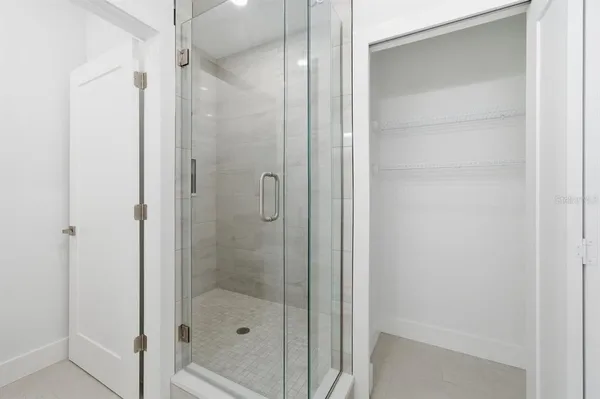 a bathroom with double vanity sinks and a mirror