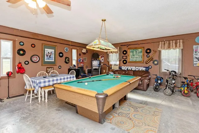 a living room with furniture a table and a chandelier