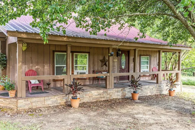a front view of a house with outdoor seating
