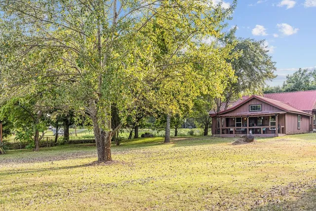 a house with swimming pool in front of it