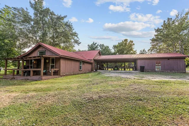 a view of a house with a yard and sitting area