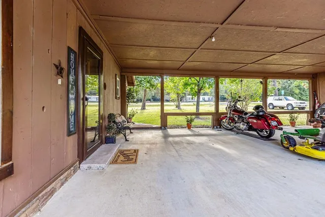 a view of a garage with a car parked beside it