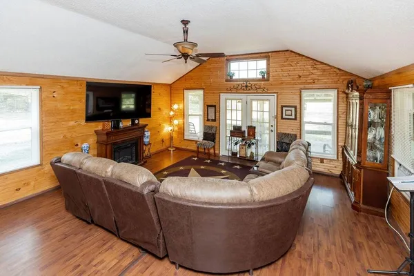 a living room with furniture a flat screen tv and a fireplace