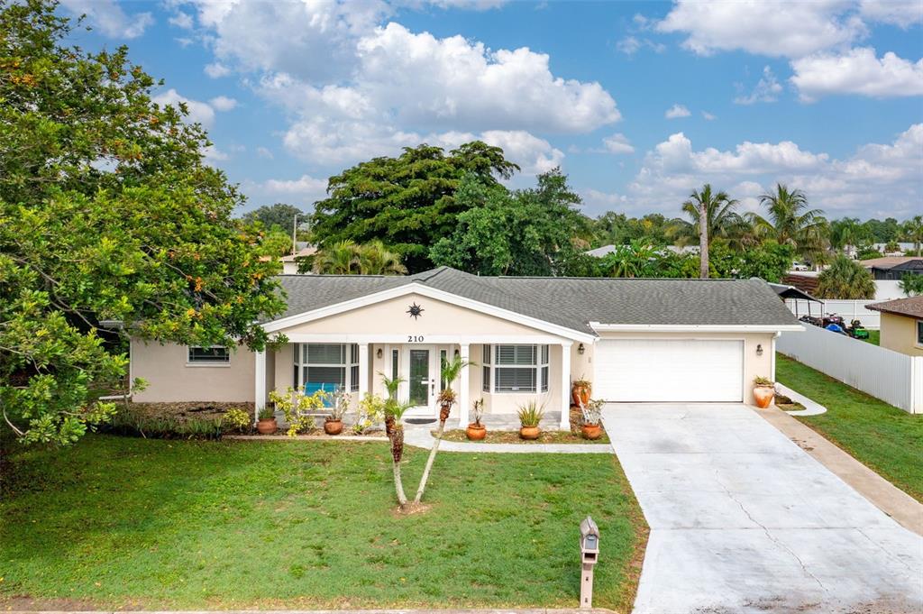 210 Jayview Drive Lehigh Acres, FL 33936 - Photo 1 of 1 a front view of a house with a yard