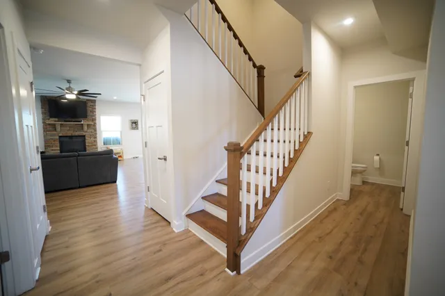 a view of a hallway with wooden floor and staircase