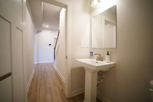 a bathroom with a sink a mirror and a toilet