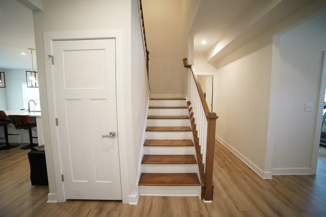 a view of entryway with wooden floor and stairs