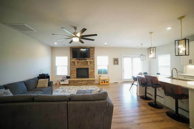 a living room with furniture and a fireplace