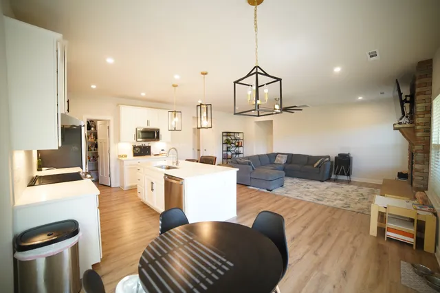 a living room with kitchen island furniture and a wooden floor