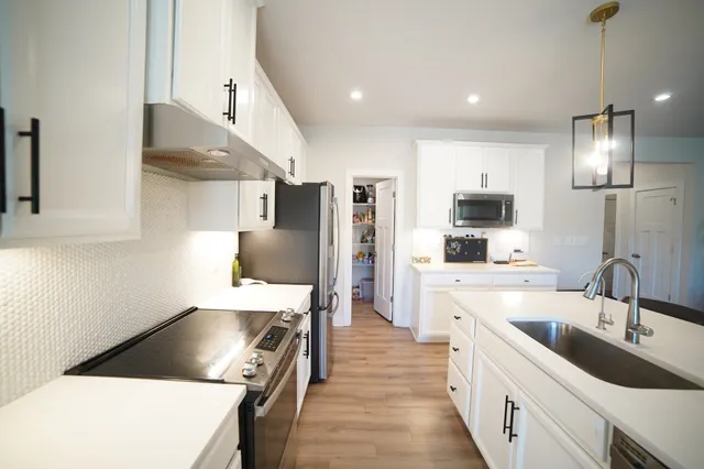 a kitchen with a sink stove and refrigerator