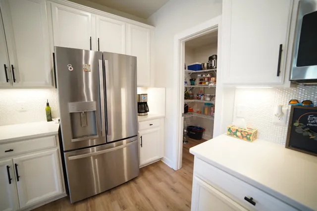 a kitchen with stainless steel appliances a refrigerator and a stove top oven