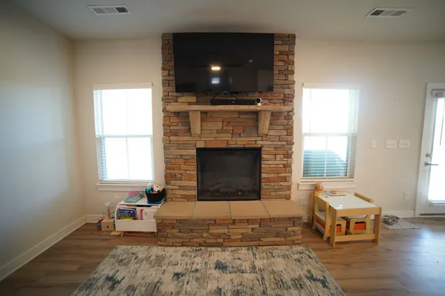 a living room with furniture and a fireplace