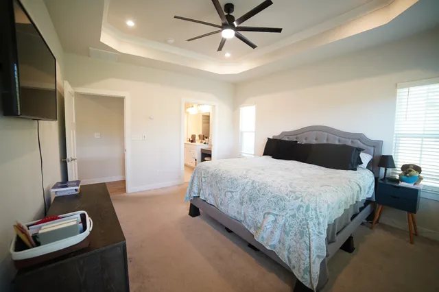 a bedroom with a bed and a flat tv screen