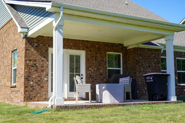 a view of a front door and small yard