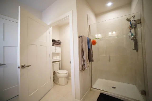 a bathroom with a shower a toilet and sink