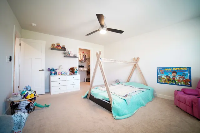 a bedroom with furniture and a wooden floor