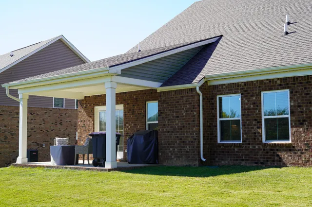 a view of a brick house with a swimming pool