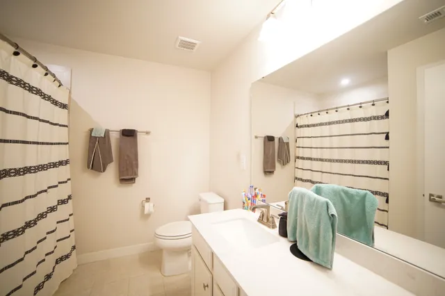 a bathroom with a toilet a sink and bath tub