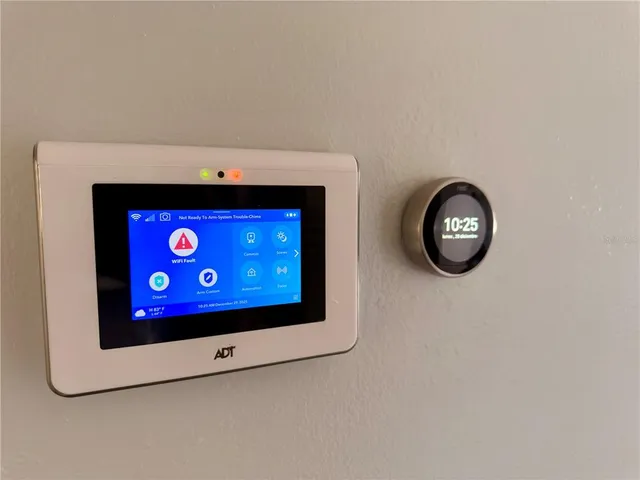 a view of an empty room with wooden floor and a wall painting