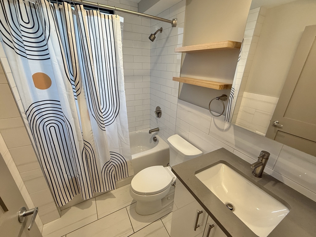 244 Hanover Street, Unit 610 Boston, MA 02113 - Photo 5 of 15 a bathroom with a sink toilet and shower