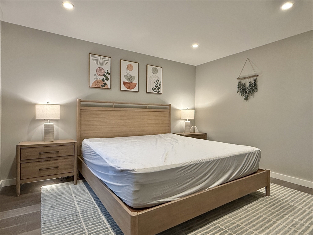 244 Hanover Street, Unit 610 Boston, MA 02113 - Photo 10 of 15 a bedroom with a bed and lamp