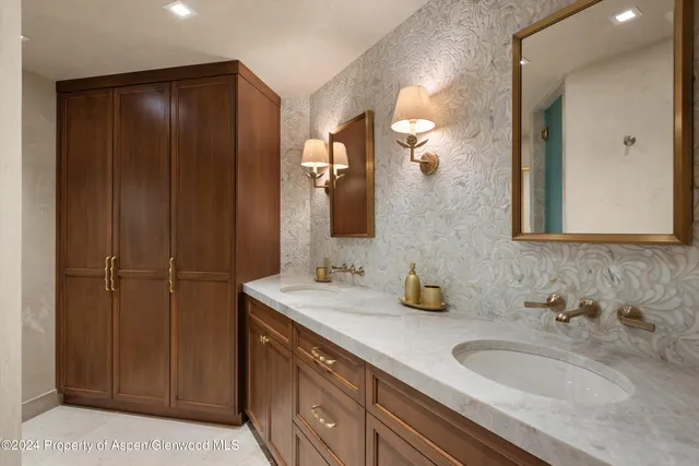 a bathroom with a double vanity sink and a mirror