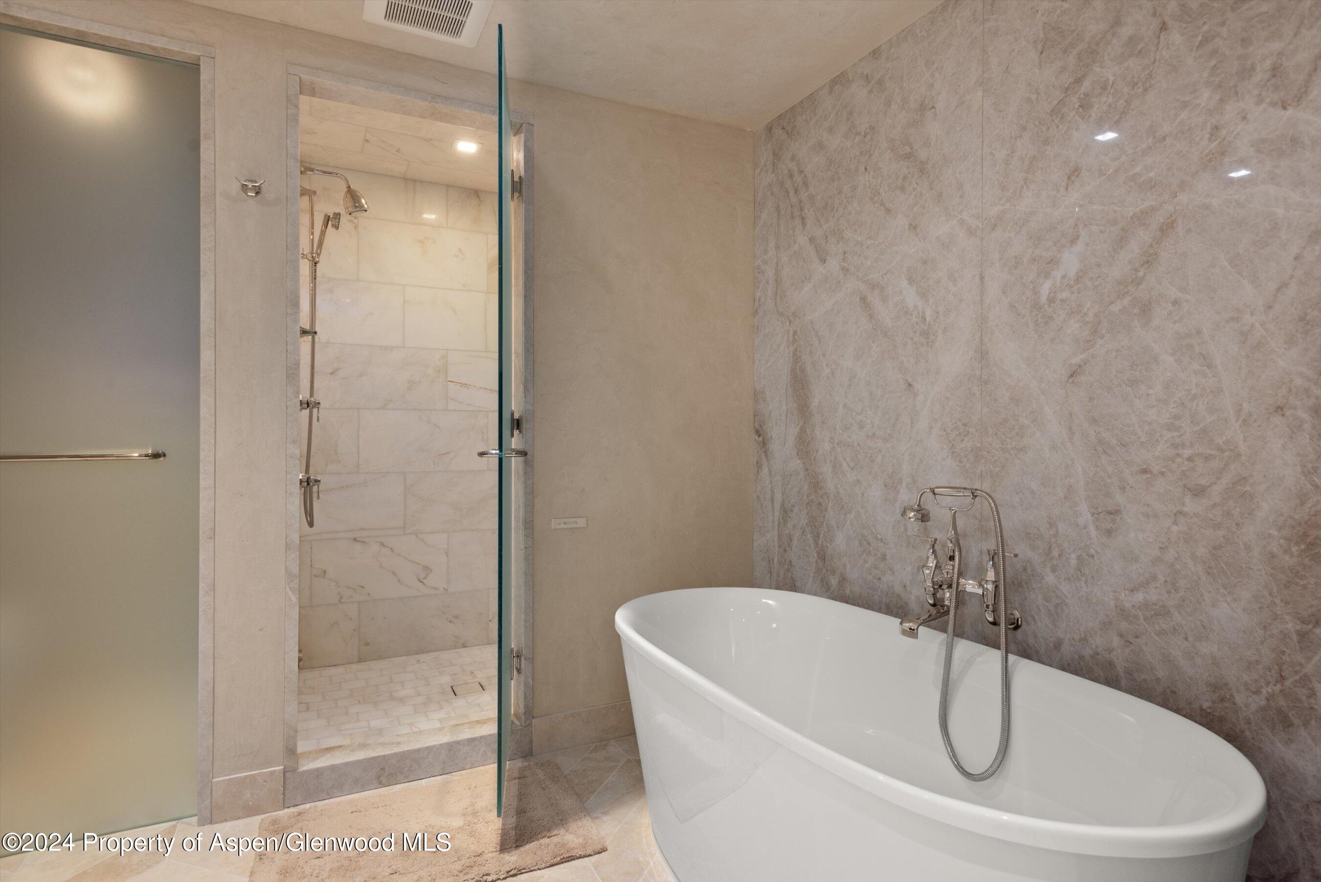 1439 Crystal Lake Road Aspen, CO 81611 - Photo 12 of 34 a white bath tub sitting next to a shower