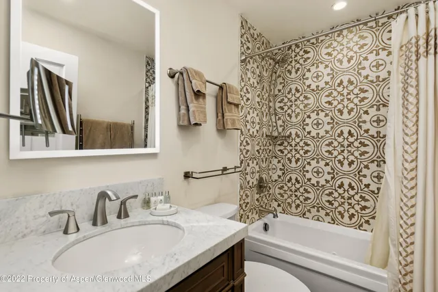 a view of a patio with couches table and chairs with wooden floor