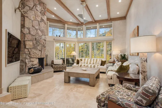 a spacious bedroom with furniture and a large window