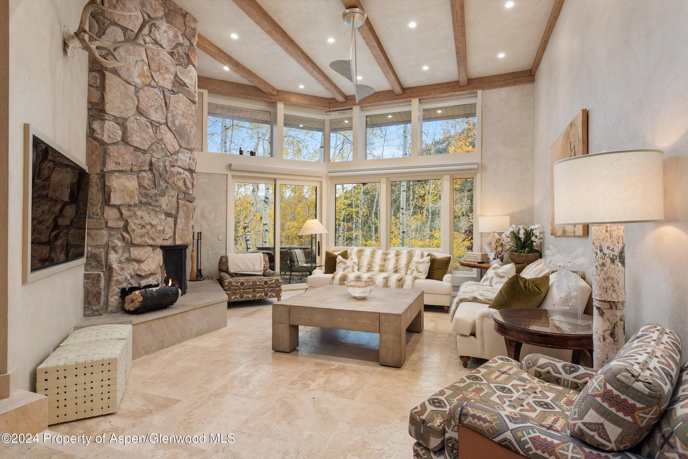 1439 Crystal Lake Road Aspen, CO 81611 - Photo 2 of 34 a spacious bedroom with furniture and a large window
