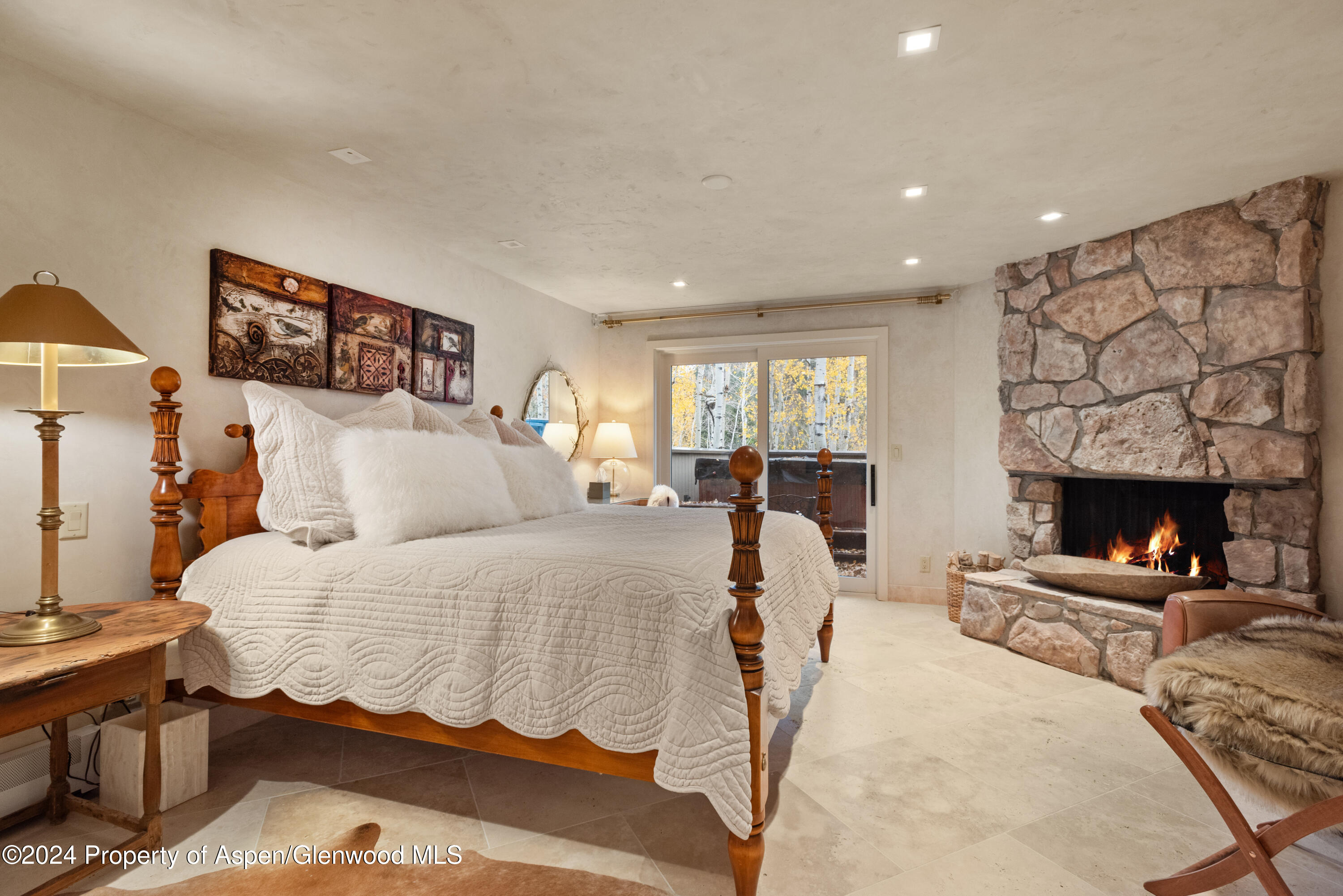 1439 Crystal Lake Road Aspen, CO 81611 - Photo 29 of 34 a bedroom with a bed and a fireplace