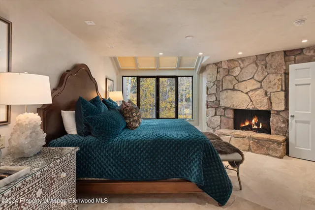 a bedroom with a bed and a fireplace