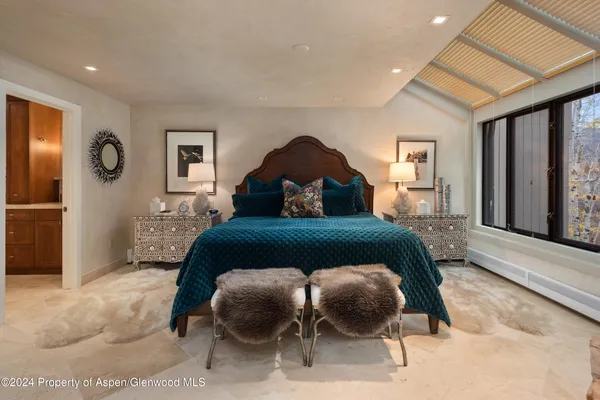 a bedroom with a bed and window