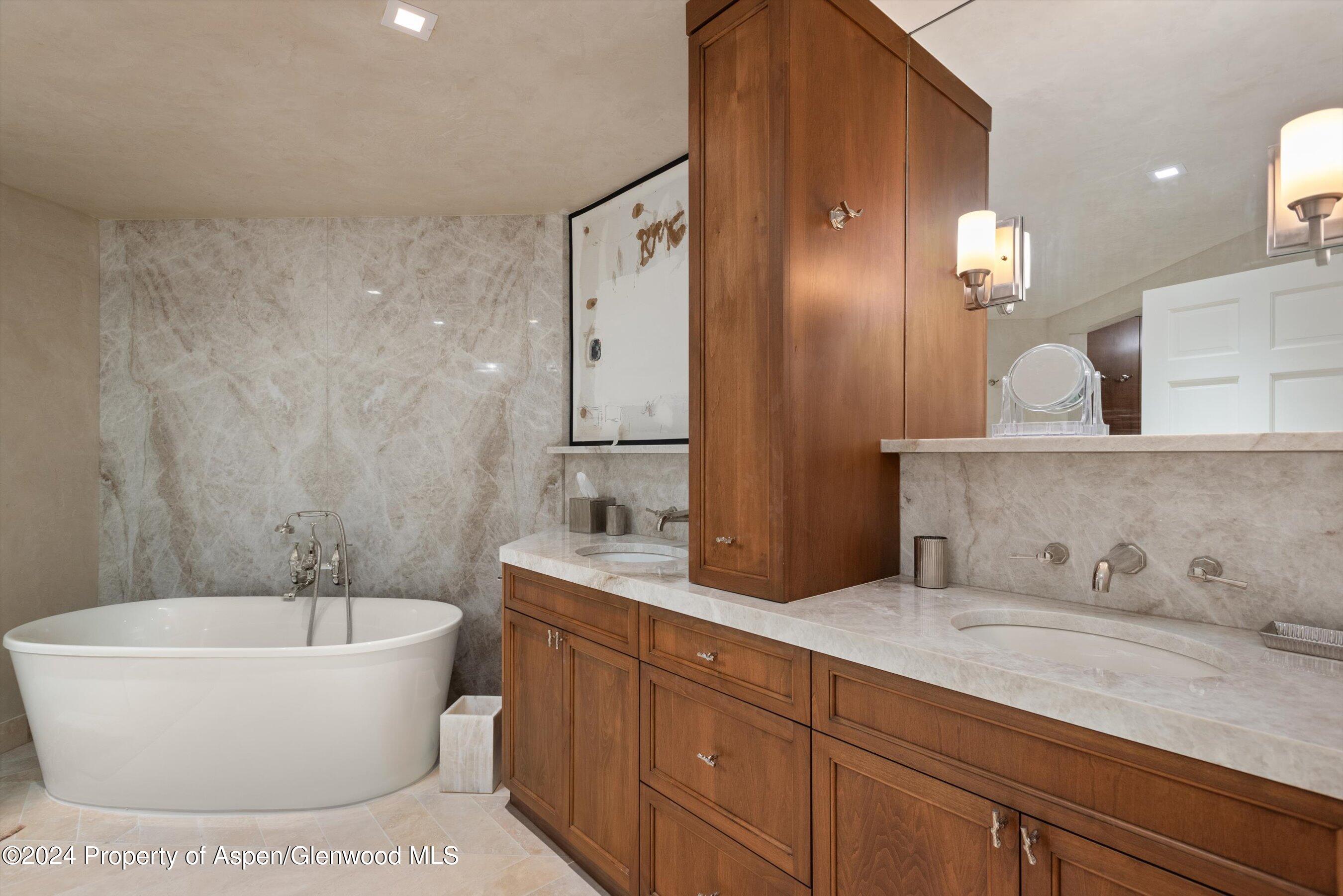 1439 Crystal Lake Road Aspen, CO 81611 - Photo 10 of 34 a spacious bathroom with a bathtub sink and mirror