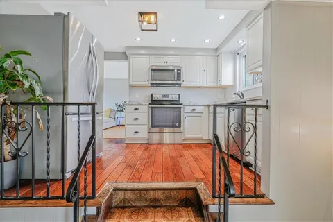 a view of a kitchen with furniture and staircase