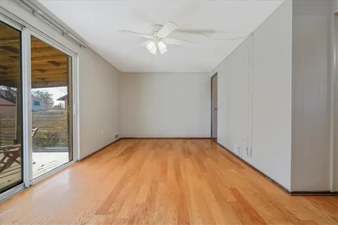 a view of an empty room with glass door